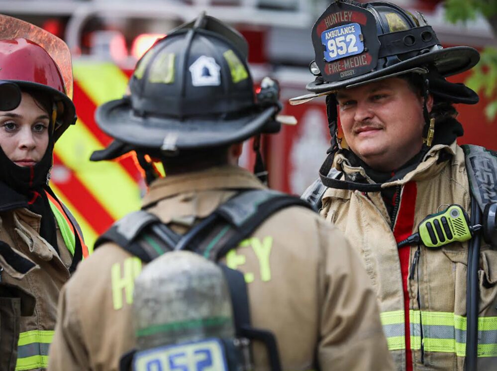 Huntley firemen and woman