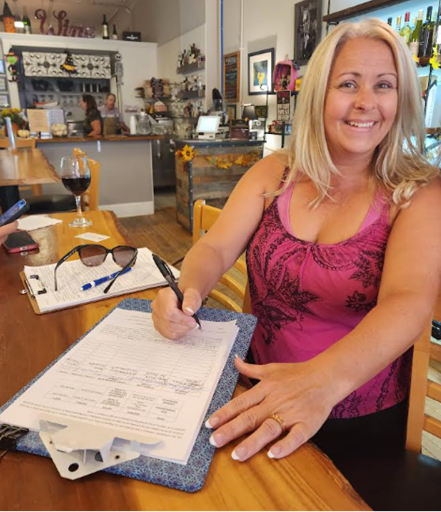 Kim woman signing petition